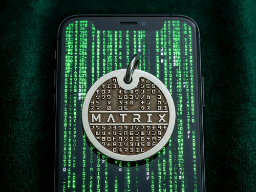 INMARK Digit pet tag on phone with Matrix code background